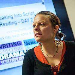 A person speaks in front of a presentation screen displaying text about script reading and drama writing.
