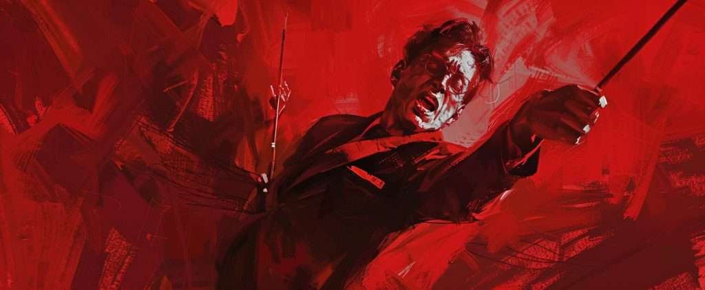 A person in glasses passionately conducts with two batons against a dynamic red background.